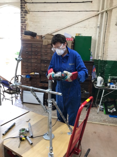 Hazel on the angle-grinder cutting tube lengths
