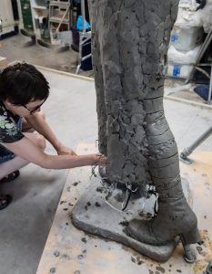 Hazel Reeves working on Emmeline's skirt - photo by Nigel Kingston