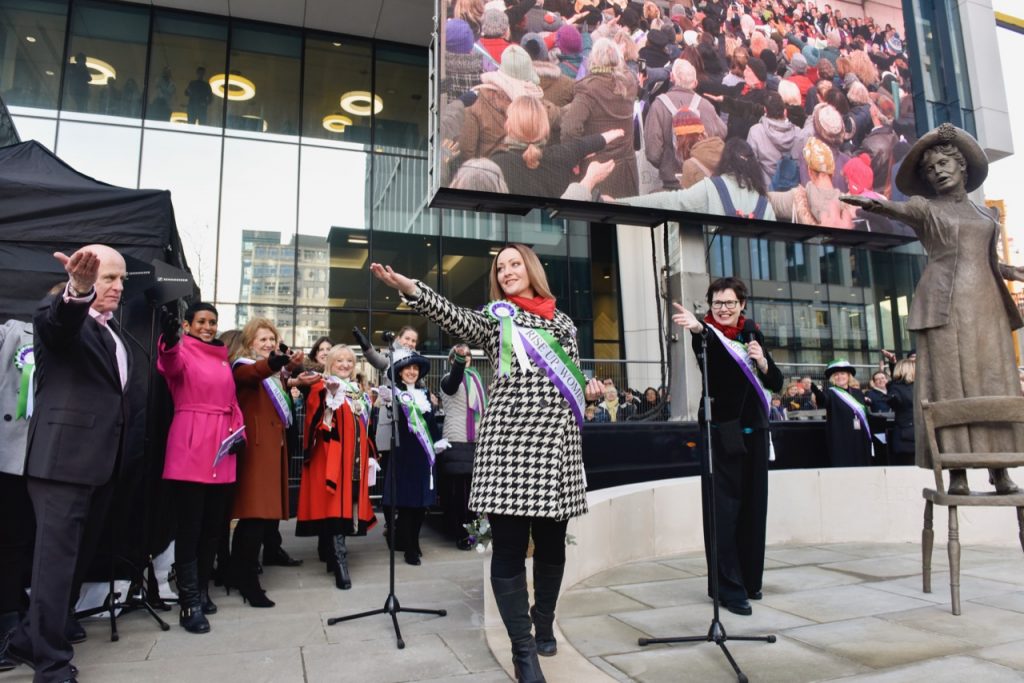 Sarah Jenkins and Hazel Reeves lead the crowd in adopting the Our Emmeline pose