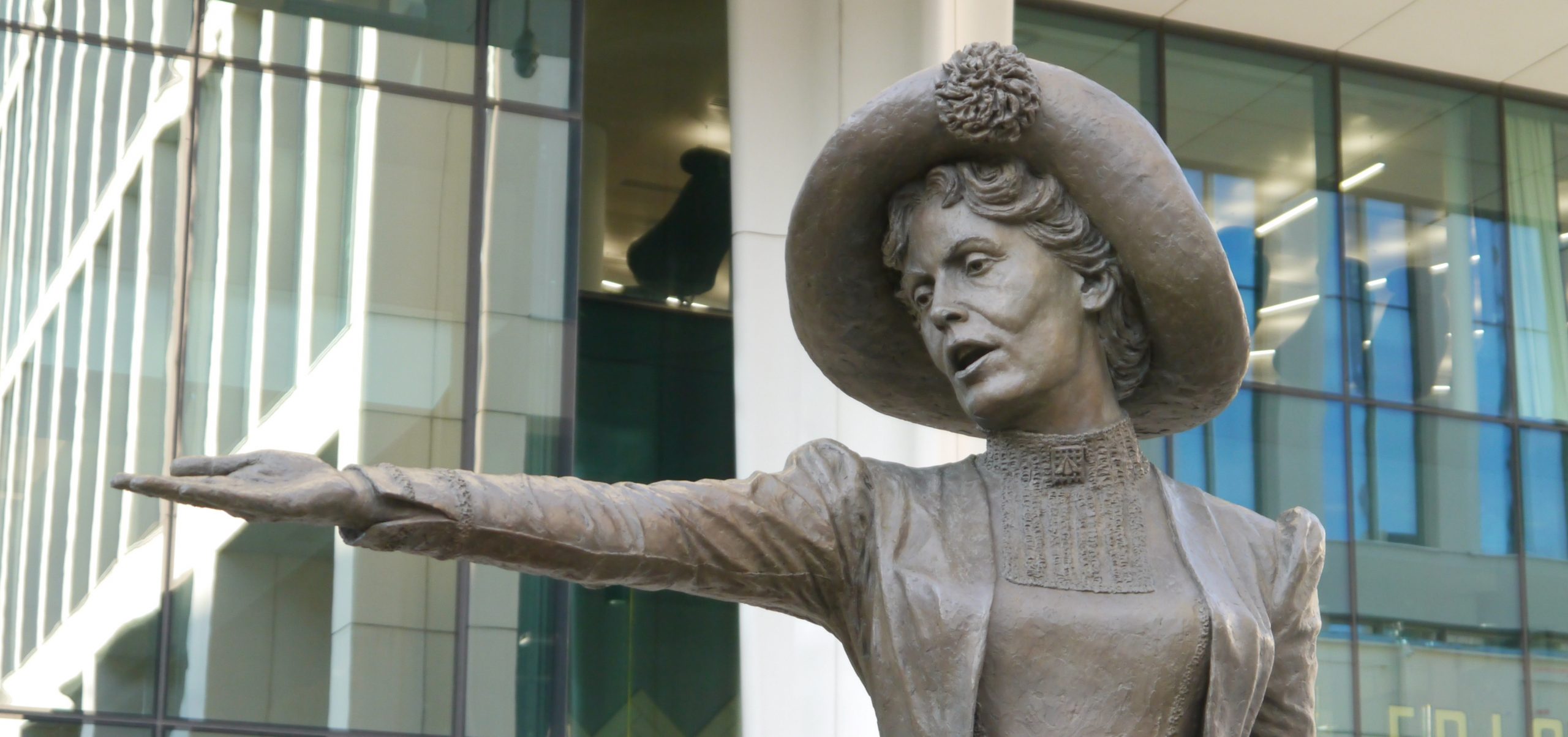 Photo show image of the Emmeline Pankhurst statue, with her arm oustretched to urge women to demand the vote