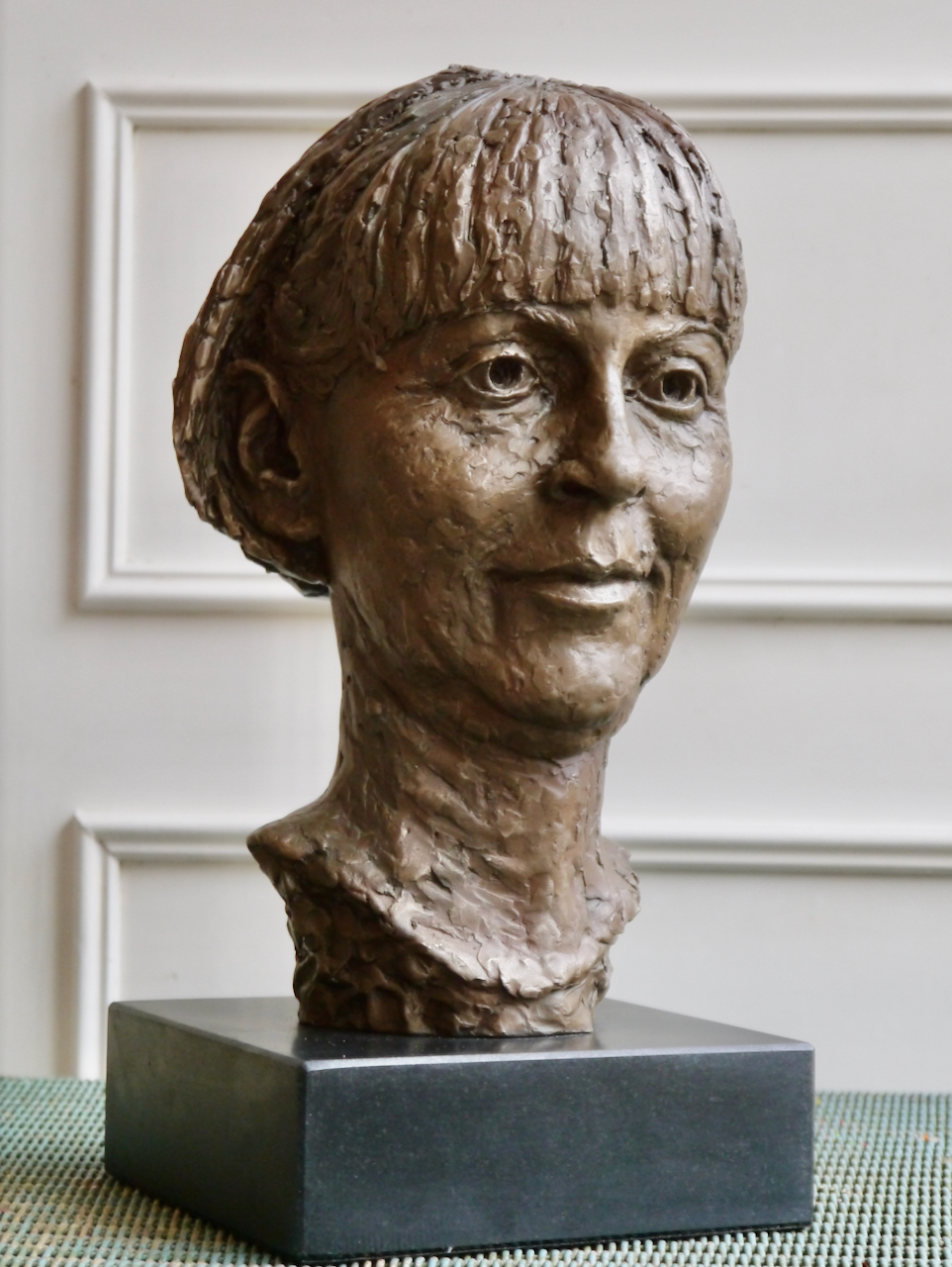Portrait head in bronze of disability rights campaigner Baroness Jane Campbell of Surbiton DBE. Her hair is in a short bob worn with an 'alice band'